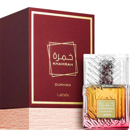 Khamrah Dukhan perfume bottle with packaging on a white background